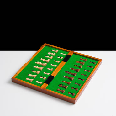 Wooden chess set with pieces on a green felt board