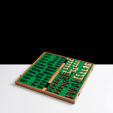 Wooden chess set with pieces on a green felt board