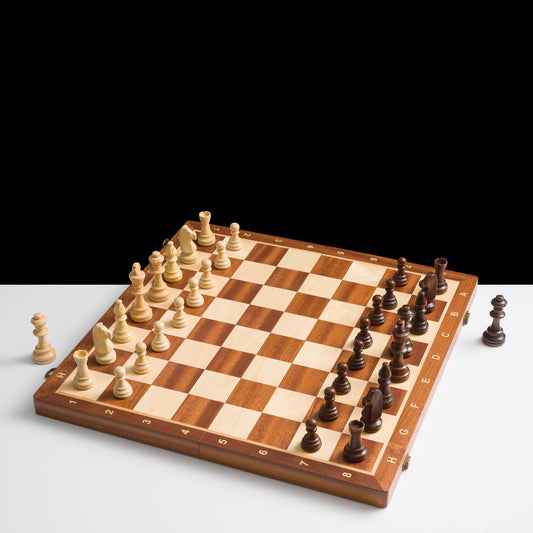 Wooden chessboard with pieces on a white background